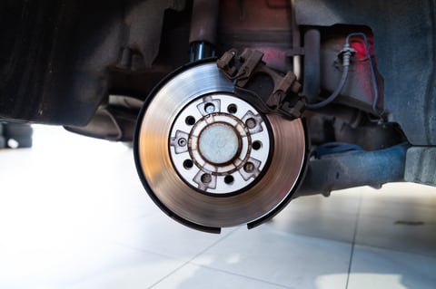 Car brake disk and caliper ready for maintenance in a professional auto service center